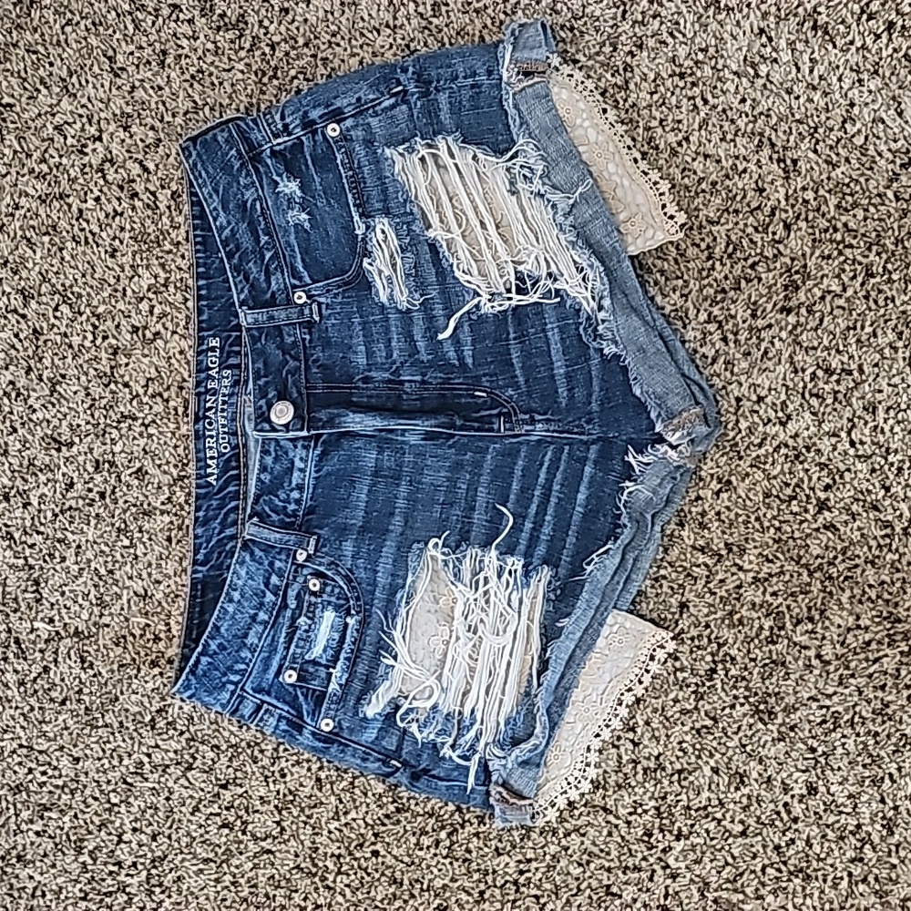 Distressed lace denim shorts